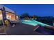 Outdoor pool at night with desert landscaping. Outdoor seating area and covered patio in view at 41611 N 113Th Pl, Scottsdale, AZ 85262