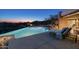 Beautiful outdoor area with an inground pool and lounge chairs with mountain views during dusk at 41611 N 113Th Pl, Scottsdale, AZ 85262