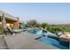Relaxing pool area with an infinity pool and spa, complete with a fire pit and lounge seating at 41611 N 113Th Pl, Scottsdale, AZ 85262