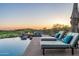 Inviting pool with lounge chairs and a fire pit overlooking a golf course at sunset at 41611 N 113Th Pl, Scottsdale, AZ 85262