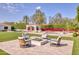 Backyard with a fire pit, pool, cabana, grass and colorful bougainvillea at 5220 N Casa Blanca Dr, Paradise Valley, AZ 85253