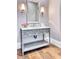Elegant bathroom featuring a marble countertop vanity with stylish fixtures and decorative lighting at 5220 N Casa Blanca Dr, Paradise Valley, AZ 85253