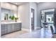 Bright bathroom featuring double sink vanity with decorative mirror and access to an outdoor spa through glass doors at 5220 N Casa Blanca Dr, Paradise Valley, AZ 85253