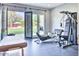 The exercise room features gym equipment and French doors that open to the green yard at 5220 N Casa Blanca Dr, Paradise Valley, AZ 85253
