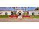 Welcoming entrance framed by palm trees and colorful floral displays leading to an arched doorway at 5220 N Casa Blanca Dr, Paradise Valley, AZ 85253