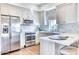 Modern kitchen featuring white cabinets, stainless steel appliances, and a functional breakfast bar at 5220 N Casa Blanca Dr, Paradise Valley, AZ 85253