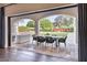 Covered outdoor dining area with dark wicker chairs and view of lush backyard at 5220 N Casa Blanca Dr, Paradise Valley, AZ 85253