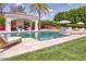 Stunning backyard oasis featuring a sparkling pool, lounge area, lush landscaping, and outdoor entertainment space at 5220 N Casa Blanca Dr, Paradise Valley, AZ 85253