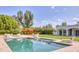 Beautiful pool with lawn chairs, lush landscaping, and modern home at 5220 N Casa Blanca Dr, Paradise Valley, AZ 85253