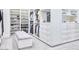 A well-organized walk-in closet with custom shelving, hanging rods, drawers, and a plush bench, maximizing storage and style at 5220 N Casa Blanca Dr, Paradise Valley, AZ 85253