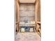 The wine cellar is a custom-built space with wood paneling and marble counters, designed to showcase and preserve wine collections at 5220 N Casa Blanca Dr, Paradise Valley, AZ 85253
