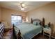 Cozy bedroom with a large window, ceiling fan, and comfortable bedding at 5450 E Deer Valley Dr # 1201, Phoenix, AZ 85054