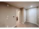 A well-lit hallway showcasing neutral tones, doorways to other rooms, and tiled flooring at 5450 E Deer Valley Dr # 1201, Phoenix, AZ 85054