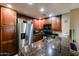 Well-lit kitchen with stainless steel refrigerator, granite counters, and wooden cabinets at 5450 E Deer Valley Dr # 1201, Phoenix, AZ 85054