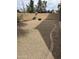Low-maintenance backyard with neutral rock landscaping, brick perimeter wall and a built-in fire pit at 5734 W Gwen St, Laveen, AZ 85339