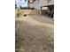 Large, low-maintenance backyard featuring neutral rock landscaping, brick perimeter wall and a covered patio at 5734 W Gwen St, Laveen, AZ 85339