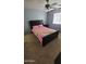 Bedroom features carpet, gray walls, ceiling fan, window with blinds, and a black upholstered bed frame at 5734 W Gwen St, Laveen, AZ 85339
