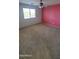 Bedroom featuring a ceiling fan, neutral carpet, and a painted accent wall at 5734 W Gwen St, Laveen, AZ 85339