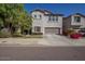 Charming two-story home featuring a front yard with a two-car garage and a neutral-colored stucco facade at 5734 W Gwen St, Laveen, AZ 85339