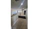 Bright hallway with neutral walls and carpeted floor leading to bedrooms and bathrooms at 5734 W Gwen St, Laveen, AZ 85339