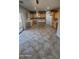 Bright kitchen with tiled floors, featuring an island, wooden cabinets, and sliding glass doors for natural light at 5734 W Gwen St, Laveen, AZ 85339