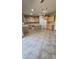 Spacious kitchen with a large center island, wood cabinets, tile floors, and white appliances, offering functionality and style at 5734 W Gwen St, Laveen, AZ 85339