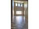 Bright living room boasts soaring ceilings, neutral walls, and tile flooring, creating a spacious and inviting atmosphere at 5734 W Gwen St, Laveen, AZ 85339