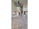 Open-concept home features a living room with tile floors, a ceiling fan, and staircase leading to the upper level at 5734 W Gwen St, Laveen, AZ 85339