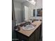 Bathroom featuring a double sink vanity, spacious mirror, and tiled backsplash at 7300 N 51St Ave # A259, Glendale, AZ 85301