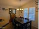 Inviting dining room with ample natural light, a modern chandelier, and seating for six at 7300 N 51St Ave # A259, Glendale, AZ 85301