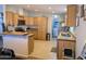 Spacious kitchen with stainless steel appliances, tile countertops, and bar stool seating at 7300 N 51St Ave # A259, Glendale, AZ 85301