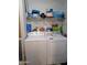 Bright laundry area featuring full-sized washer and dryer, with shelving for supplies at 7300 N 51St Ave # A259, Glendale, AZ 85301