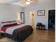 Serene main bedroom with a ceiling fan, hardwood flooring, and access to a walk-in closet at 7300 N 51St Ave # A259, Glendale, AZ 85301