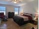 Relaxing main bedroom featuring hardwood floors, ample natural light, and comfortable furnishings at 7300 N 51St Ave # A259, Glendale, AZ 85301