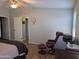 Comfortable main bedroom with hardwood flooring, a ceiling fan, and a cozy reading chair at 7300 N 51St Ave # A259, Glendale, AZ 85301