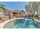 Lush backyard oasis featuring a pool, outdoor seating area, and well-maintained landscaping at 7433 W Darrel Rd, Laveen, AZ 85339