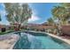 Sparkling pool with artificial turf, landscaping and patio area at 7433 W Darrel Rd, Laveen, AZ 85339