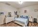 Well-lit bedroom with laminate floors, neutral walls, and a queen bed and two nightstands at 7433 W Darrel Rd, Laveen, AZ 85339