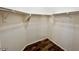 Bright walk-in closet features sturdy shelving and hardwood-style flooring at 7433 W Darrel Rd, Laveen, AZ 85339