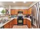 Functional kitchen featuring wood cabinetry, modern appliances, and ample counter space at 7433 W Darrel Rd, Laveen, AZ 85339