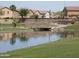 Scenic community pond view with a wooden bridge and well-maintained landscaping at 7433 W Darrel Rd, Laveen, AZ 85339