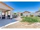 Inviting backyard featuring an outdoor kitchen, covered patio, pool area, landscaping, and space for relaxing at 7670 W Sands Dr, Peoria, AZ 85383