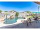 Backyard retreat with a sparkling pool, patio, lounge chairs, lush greenery, creating the perfect outdoor living space at 7670 W Sands Dr, Peoria, AZ 85383