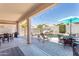Outdoor oasis featuring a stunning pool with a rock waterfall, dining furniture, and spacious patio at 7670 W Sands Dr, Peoria, AZ 85383