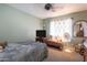 Cozy bedroom featuring natural lighting, a ceiling fan, and minimal decor at 7670 W Sands Dr, Peoria, AZ 85383