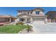 Charming two-story home featuring lush landscaping and a two car garage with a classic desert color palette at 7670 W Sands Dr, Peoria, AZ 85383