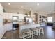 Modern kitchen with stainless steel appliances, an island with seating, and bright white cabinetry at 7670 W Sands Dr, Peoria, AZ 85383