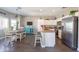 Spacious kitchen with stainless steel appliances, an island, and an adjacent dining area at 7670 W Sands Dr, Peoria, AZ 85383