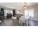 Open-concept living room featuring dark floors, natural light, neutral colored paint, and dining area at 7670 W Sands Dr, Peoria, AZ 85383