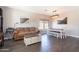 Spacious living room featuring dark floors, natural light, neutral colored paint, and dining area at 7670 W Sands Dr, Peoria, AZ 85383